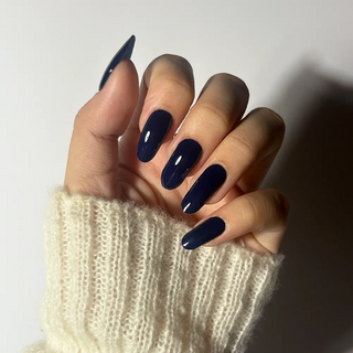 Hand wearing EyeCandys Midnight Magic Gel Nail Sticker – deep navy blue nails with a sleek, glossy finish. Elegant DIY gel manicure ideal for work, casual, or evening looks. Non-toxic, vegan, and long-lasting.