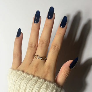 Applying EyeCandys Midnight Magic Gel Nail Sticker – classic dark blue manicure with a polished, sophisticated sheen. Perfect for timeless everyday wear or chic nighttime outfits. Vegan, cruelty-free, and durable gel nails.