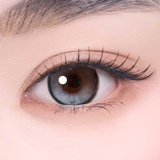 i-Sha Reborn Moon Stone color contact lens on top of a dark eye paired with subtle eye makeup and curled wispy eyelashes,