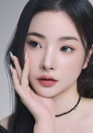 A female model with natural dark eyes wearing i-Sha Reborn Moon Stone contact lenses