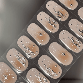 EyeCandys Papillon Gel nail sticker featuring a soft nude base with elegant black butterfly wing accents, glitter specks, and delicate star details. This semi-cured gel design blends whimsy and sophistication, perfect for romantic, ethereal manicures with a salon-quality finish.