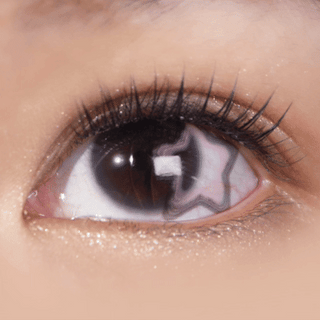 Macro eye shot wearing EyeCandys Pink Star contact lens – pastel star design perfectly placed on dark iris for a subtle, enchanting look.