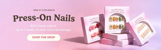 EyeCandys press on nails assortment on pink backdrop showcasing trending reusable nail sets with floral, chrome, marble, and glitter nail designs.