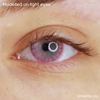 close up eye wearing eyecandys shade pink contact lenses on top of a light color iris.