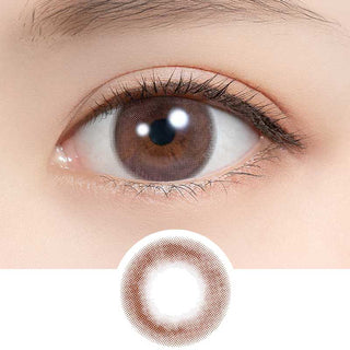 Close-up of dark eye wearing EyeCandys Sakura Mousse colored contact lens with lens design shown below – enhances natural eye color with a soft brown tint. Available as color contact lenses and prescription colored contact lenses
