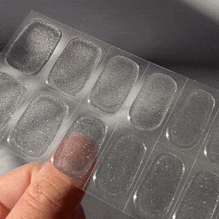 Step two of applying EyeCandys Gel Nail Stickers: finding the perfect sticker size for each nail, ensuring a precise fit for a flawless, long-lasting gel manicure