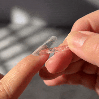 Step six of applying EyeCandys Gel Nail Stickers: pushing the edge of the sticker with a stick for a smooth, precise application and long-lasting gel manicure