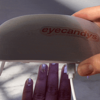 Step seven of applying EyeCandys Gel Nail Stickers: curing with UV light to harden the stickers for a glossy, salon-quality finish and long-lasting gel manicure