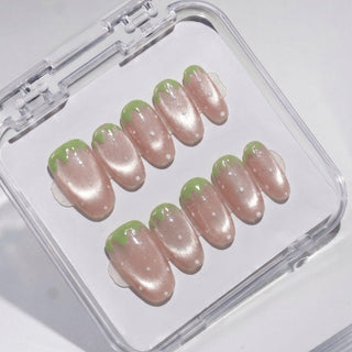 EyeCandys Strawbelina press on nails featuring rosy pink shimmer nails with white seed dots and jagged green tip strawberry design.