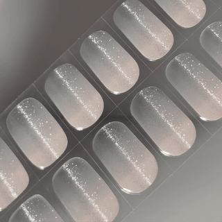 EyeCandys Sugar Cookie Gel nail sticker featuring a soft translucent base with fine silver glitter, creating a delicate, frosted effect. This semi-cured gel set is perfect for minimalist, winter-inspired looks with an easy, salon-quality finish and long-lasting wear.