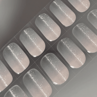 EyeCandys Sugar Cookie Gel nail sticker featuring a soft translucent base with fine silver glitter, creating a delicate, frosted effect. This semi-cured gel set is perfect for minimalist, winter-inspired looks with an easy, salon-quality finish and long-lasting wear.