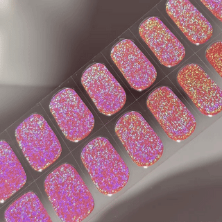 EyeCandys Supernova Gel nail sticker featuring a bold, multidimensional glitter in hot pink, violet, and gold tones. This semi-cured gel set creates a dazzling, holographic effect—perfect for party-ready manicures with cosmic sparkle and long-lasting shine.