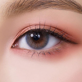 Macro shot of an eye wearing the Olola Able Blue (KR) prescription colour contact lens, showing the multi-colored detail and natural effect on dark brown eyes.