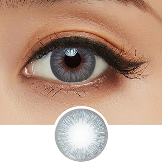 Close-up shot of model's eye adorned with Acuvue 1-Day New Define Fresh Blue color contact lens dailies, complemented by clean eye makeup, showing the brightening effect of the blue contact lens on dark brown eyes, above a cutout of the colour contact lens design with radial spiked pattern.