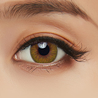 Close-up shot of model's eye adorned with Acuvue 1-Day New Define Green color contact lens dailies, complemented by clean eye makeup, showing the brightening effect of the green contact lens on dark brown eyes.