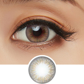 Close-up shot of model's eye adorned with Acuvue 1-Day New Define Fresh Greyzel (Grey-Hazel) color contact lens dailies, complemented by clean eye makeup, showing the brightening effect of the grey contact lens on dark brown eyes, above a cutout of the colour contact lens design with radial spiked pattern.