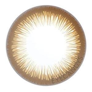 Closeup of Acuvue Define Radiant Bright Brown prescription color contact lens (circle lens) design, showcasing a dark limbal ring, on a white background.