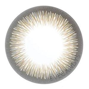 Closeup of Acuvue Define Radiant Charm Brown prescription color contact lens (circle lens) design, showcasing a dark limbal ring, on a white background.