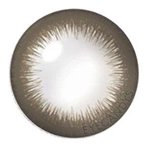 Closeup of Acuvue Define Radiant Sweet Choco prescription color contact lens (circle lens) design, showcasing a dark limbal ring, on a white background.