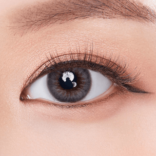 Macro shot of an eye wearing the Olola Dazzling 1-Day Ice Grey (10pk) (KR) prescription colour contact lens, showing the multi-colored detail and natural effect on dark brown eyes.
