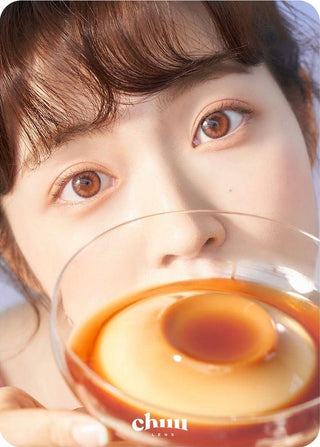 Asian model demonstrating a K-idol-inspired look with Chuu Cloud Pudding Pink Brown (10pk) coloured contact lenses, highlighting the instant brightening and enlarging effect of the circle contact lenses over dark irises.