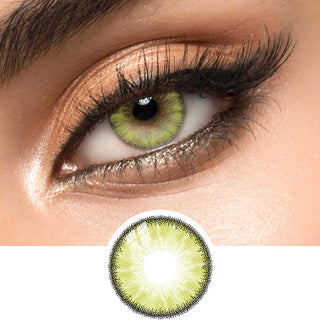 Close-up shot of a model eye wearing Desire Lush Green colored contact lens in one eye that is naturally dark-brown with natural light gold eye make up