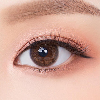 Macro shot of an eye wearing the Olola Dewie Brown (KR) prescription colour contact lens, showing the multi-colored detail and natural effect on dark brown eyes.