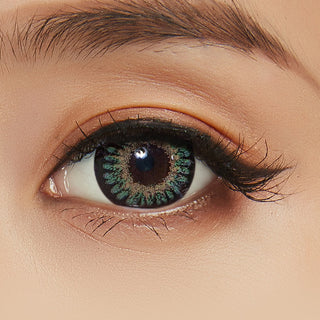 Close-up of model's eye with Bambi Green contact lens and peach eyeshadow