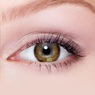 Close-up shot of model's eye adorned with Eyelighter Brown colored contacts for astigmatism, complemented by clean eye makeup