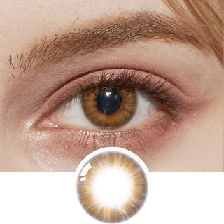 A detailed shot of a model's eye showcasing the Pink Label Flirty Orange Brown contact lens, accompanied by peach-colored eyeshadow, with a depiction of the lens placed beneath for comparison.