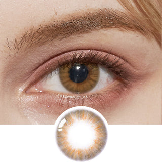 Model sporting Pink Label Flirty Honey Brown contact lenses paired with peach eyeshadow. Furthermore, there's an accompanying image presenting a cut-out of the identical lens.