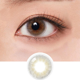 Macro shot of an eye wearing the Olola Able Grey (KR) colour contact lens, showing the multi-colored detail and natural effect on dark brown eyes, with clean eye makeup