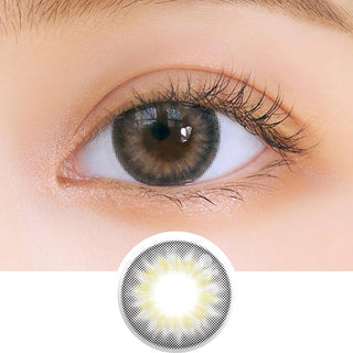 Close-up shot of model's eye adorned with Chuu Sunny Cookie Grey daily color contact lenses with prescription, complemented by clean eye makeup, showing the brightening and enlarging effect of the circle contact lens on dark brown eyes, above a cutout of the contact lens pattern with limbal ring on a white background.