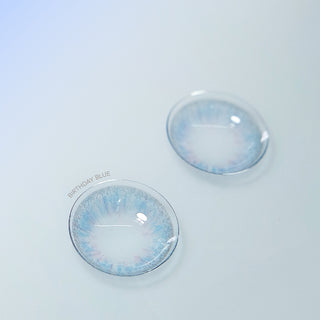 Pair of blue contact lenses from Pink Label Birthday Blue on a contrasting background