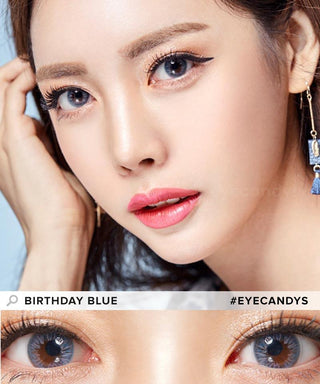Asian model presenting Birthday blue contact lenses, gesturing towards her temple with her fingers, close-up of eyes enhanced by blue contact