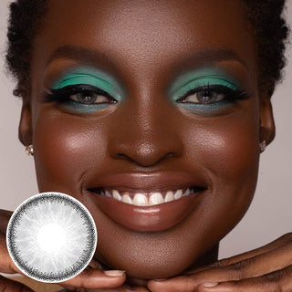 A black model with naturally dark brown eyes and green eyeshadow, wearing EyeCandys desire mist grey contact lenses, showcases a joyful expression.