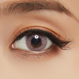 Euro Brown Color Contact Lens modelled on a dark brown eye, paired with neutral eye makeup, highlighting the opacity of the contact lens design.