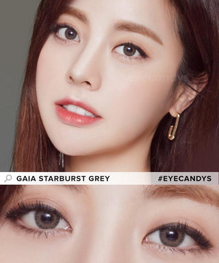 An Asian model showcases the Pink Label Starburst Grey contact lenses, paired with a touch of red lipstick, creating a distinctive appearance. The close-up image captures the eyes transformed by the grey contacts, adding a unique flair to the overall look.