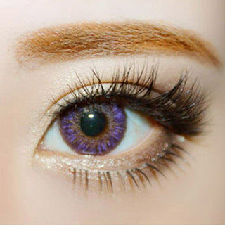 Close-up shot of a model wearing Tri-Color purple prescription colored contact lens in one eye that is naturally dark-brown
