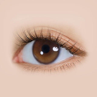 Close-up of i-DOL Yurial Serum Brown circle lens on a model's eye, showing the realistic subtle enlarging effect.