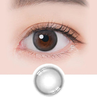 Macro shot of an eye wearing the i-Sha Ariel Grey prescription colour contact lens, showing the multi-colored detail and natural effect on dark brown eyes, with clean eye makeup. At the bottom is the pattern of the colored lens design, showing the dotted detail and pigmentation.