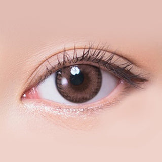 Macro shot of an eye wearing the i-Sha Shine Smile Cherry Muffin Pink prescription colour contact lens, showing the multi-colored detail and natural effect on dark brown eyes.