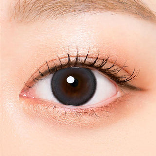 Macro shot of an eye wearing the i-Sha Oriana Mune Grey prescription colour contact lens, showing the multi-colored detail and natural effect on dark brown eyes.