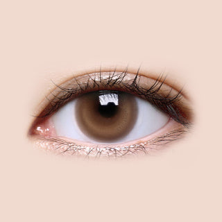 Close-up shot of model's eye adorned with LensMe LilMoon Skin Brown color contact lenses with prescription, complemented by minimalist eye makeup, showing the brightening and enlarging effect of the circle contact lens on dark brown eyes.