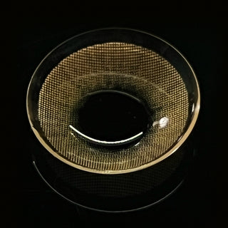Macro shot of the Libre Brown colour contact lens showing the densely dotted pattern, on a black background.