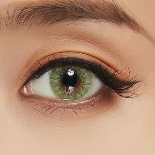 Close-up shot of a model wearing Shade Green prescription colored contact lens in one eye