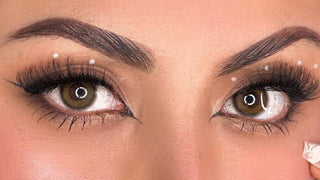 Hazel colored contacts worn with winged eyeliner, false lashes, and pearl makeup accents.
