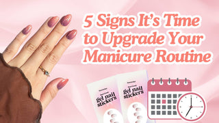 Hand with pink glitter ombre nails next to gel nail stickers, a calendar, and a clock on pink silk.