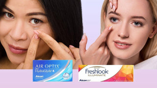 Two women inserting contact lenses beside Air Optix vs Freshlook packaging.