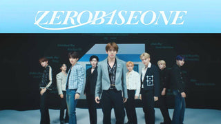 Nine Zerobaseone members stand in stylish blazers beneath a light blue ZEROBASEONE banner.